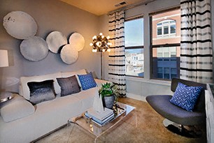 Living space with couch, coffee table and large windows